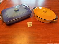 Top view of both covered dishes showing shapes, lids, colors