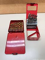 Both drill bit sets open; TiN coated set left, HSS black oxide set right