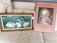 Both framed prints side by side on sofa