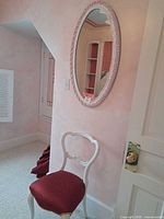 Side chair and oval mirror together for scale and style reference