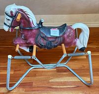 Full view of rocking horse on metal spring frame