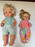 Both dolls dressed in replacement outfits