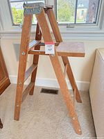 Full view of the wooden A-frame ladder front side.