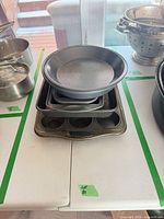 Stacked view of all pans including round, square, loaf and muffin pans