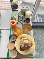 Top view of assorted candles, holders and stands on table