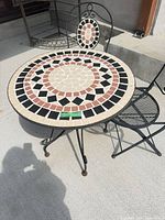 Top view of mosaic table surface and part of chair
