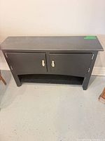 Front view of black sideboard with closed doors