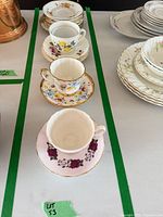 Row of teacups and saucers within lot boundary