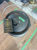 Lid of cauldron with tarot deck box resting on top