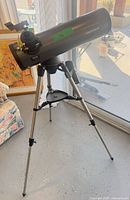 Full view of telescope on tripod showing mount and accessory tray