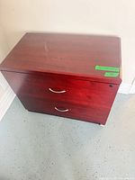 Front view of 2-drawer cherry lateral file cabinet showing handles and overall size