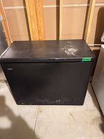 Front view of closed black Danby chest freezer showing exterior condition