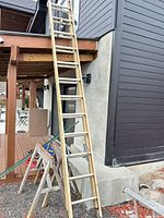 Full view of ladder leaned against building