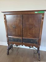 Full view of cabinet showing overall design, legs and condition