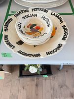 Stacked view of serving bowl with salad bowls displaying rim lettering