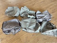 Six gray storage bags displayed flat on floor