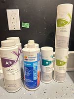 Group shot of all seven bottles on counter