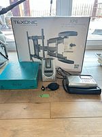 Group shot: Texonic wall mount box, blue Trivial Pursuit box, Sylvania clock radio, Grundig radio on case