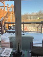 Antenna standing on table beside window