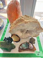Lot overview showing salt lamp, quartz geode, jade figurine, agate slice, larimar, amethyst, pyrite