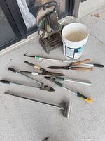 All tools laid out with chop saw, bucket and hand tools visible