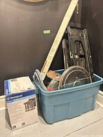 Overall lot in blue tote showing lantern box, blind package, mount, lids, hoses