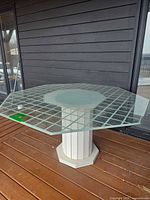Full side view of octagonal glass table on deck