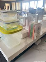 Food containers stacked beside spiralizer and blade case