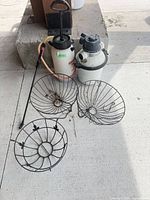 Pool filter body, Chapin sprayer, three wire hanging baskets grouped together