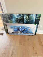 Both canvases leaning against wall showing size and subjects