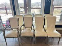 Front view of eight dining chairs showing style and upholstery