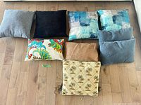 Nine pillows arranged on floor for full lot overview
