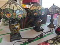 Two matching lamps and third lamp grouped on table