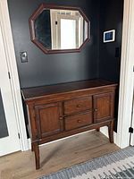 Front view of buffet sideboard beneath wall mirror