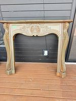 Full view of carved wood fireplace mantel surround