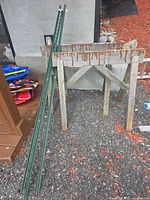Two sawhorses standing beside two T-posts
