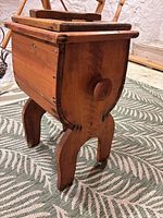 Front angled view showing wooden body, legs, finish