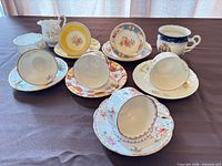 Group shot of all teacups, saucers, creamer