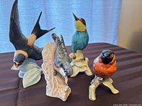 Front view of all four bird figurines on table