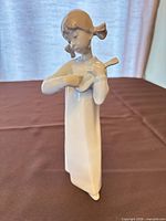 Front view of Lladró porcelain girl holding guitar