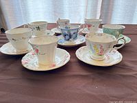Group view of eight teacup and saucer sets