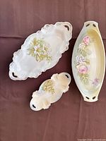 Three porcelain platters showing shape, decoration and relative sizes