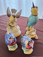 Front view showing two small Stangl birds, Goebel bird, and bird music box