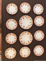 All 12 dessert plates laid out to show pattern repetition and quantity