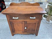 Front view of oak nightstand showing drawer, cabinet doors, hardware and overall finish