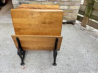 Rear view of solid wood backrest and seat on cast iron base