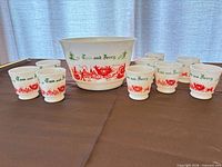 Punch bowl centered with nine matching cups displayed around
