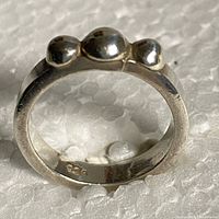 Full view of sterling silver ring showing three dome accents