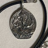 Front view of sterling silver Ganesha pendant on black cord