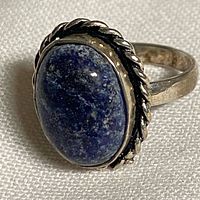 Front view showing lapis lazuli cabochon and rope bezel
